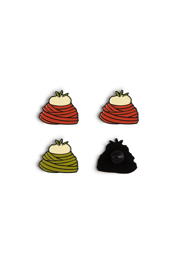 A picture of 4 metal enamel pins of a mound of tomato and pesto pasta with burrata on top of the pasta. and the back of the pin showing a clasp for the pin. 